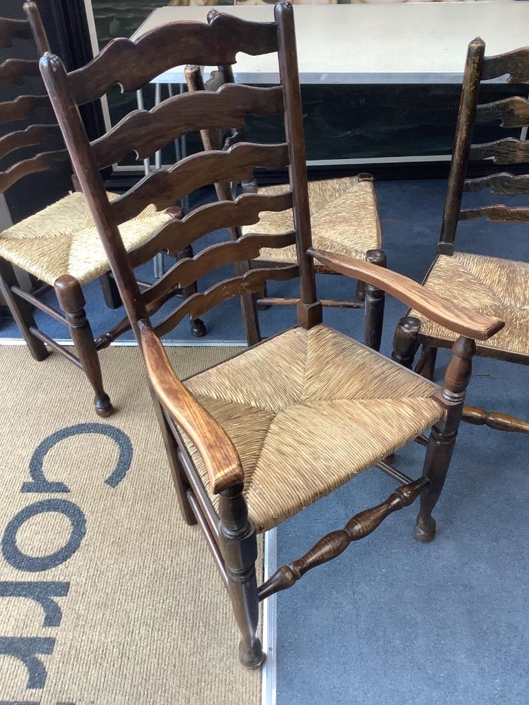 A set of twelve ash rush seat ladder back dining chairs (two with arms)